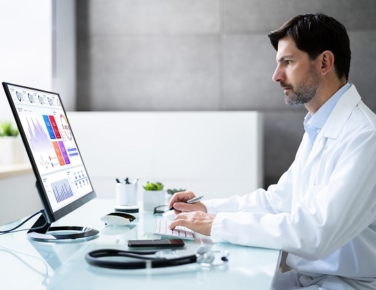 man analyzing physician data on desktop