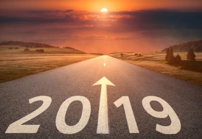 Photograph of pathway with "2019" below and an arrow pointing forward